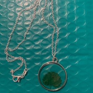 Silver necklace with a pressed flower